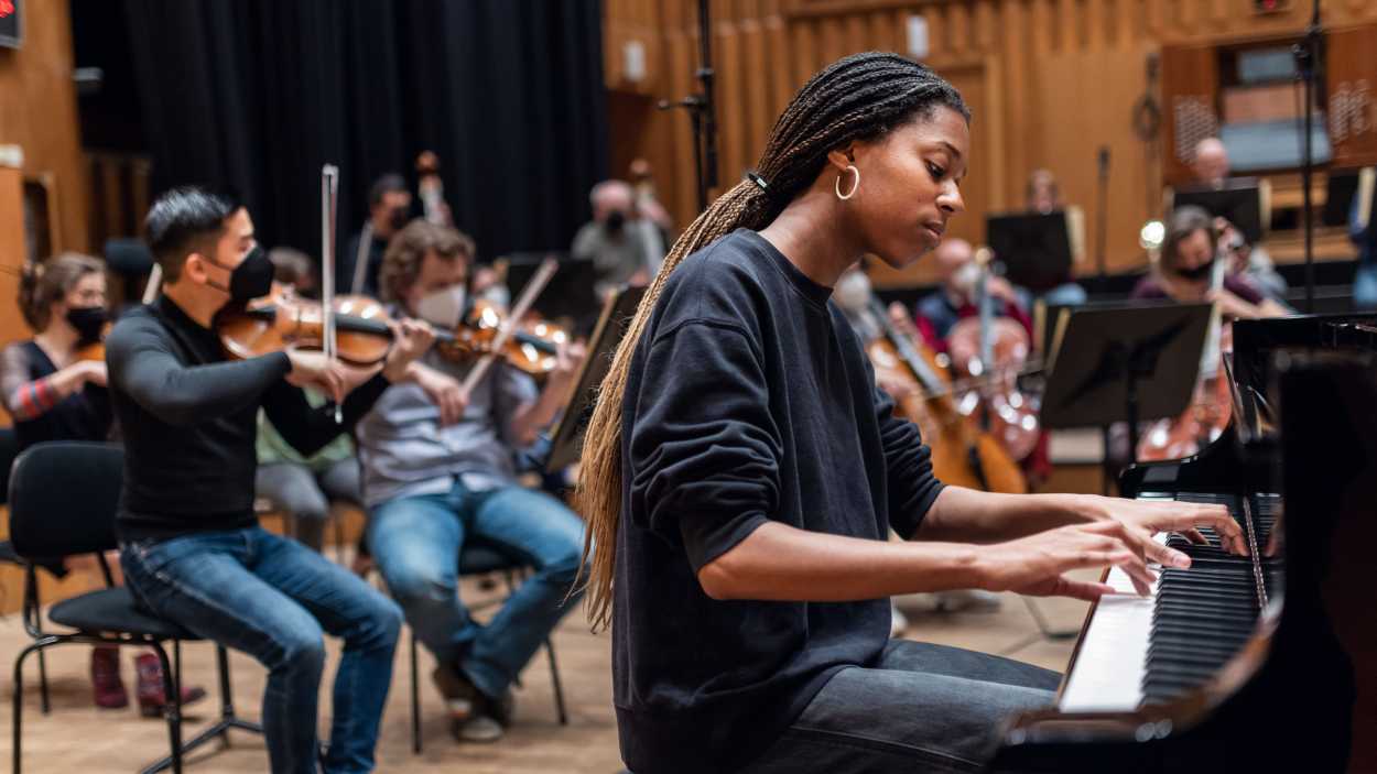 Jeneba Kanneh-Mason am Flügel, dahinter das Orchester